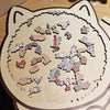 A wooden jigsaw puzzle featuring various cats in different poses and colors, designed for home decor.