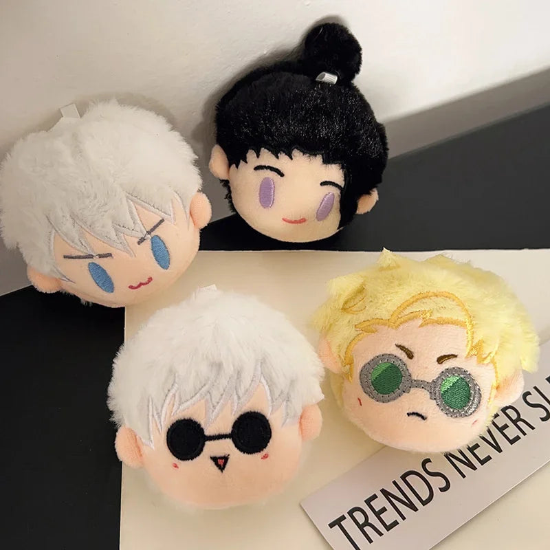 A collection of black and white Jujutsu Kaisen anime plush keychains featuring various characters.