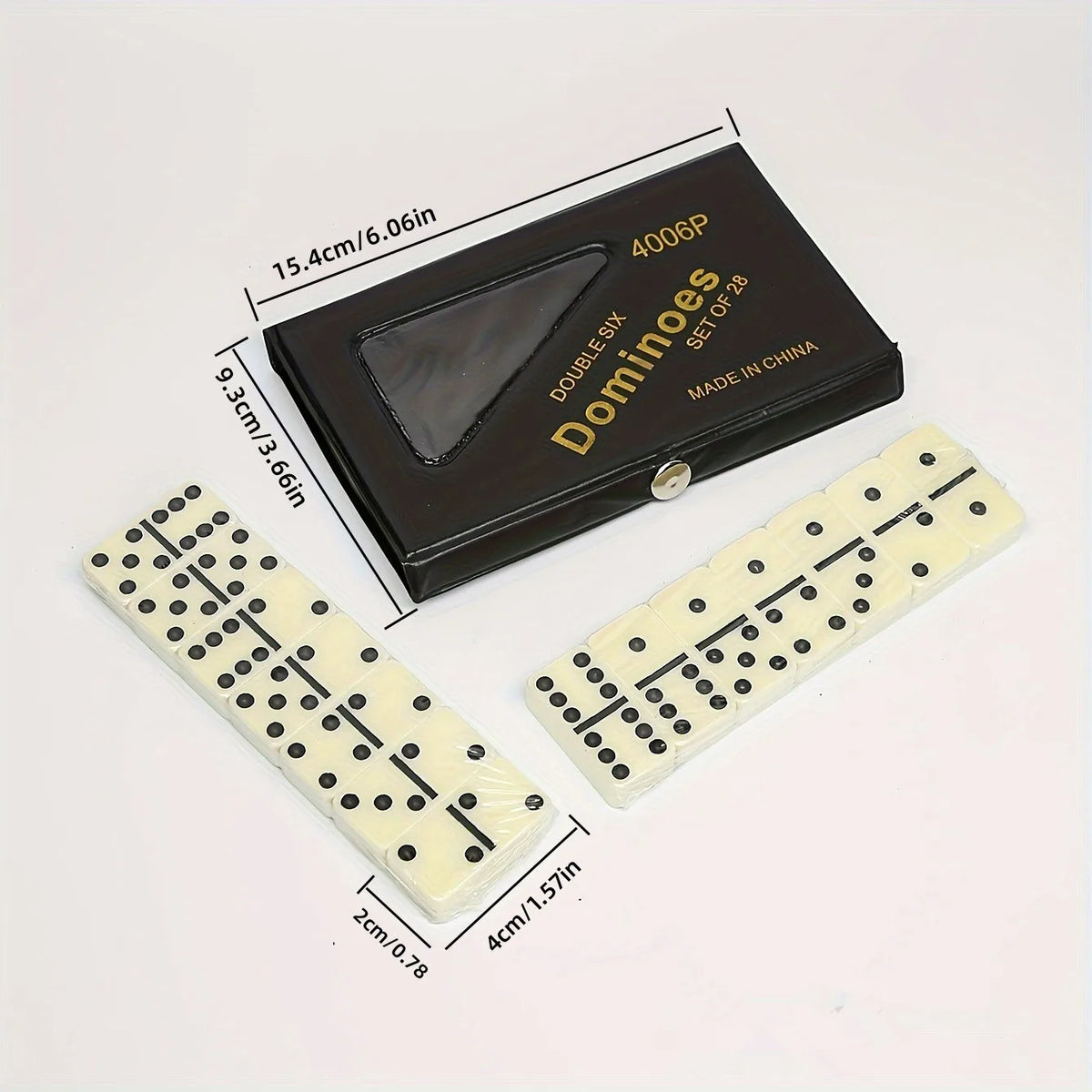 A black box containing a set of twenty-eight dominoes and two white domino tiles are displayed on a white background.