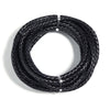 A coil of black round braided leather cord used for jewelry making and DIY crafts.