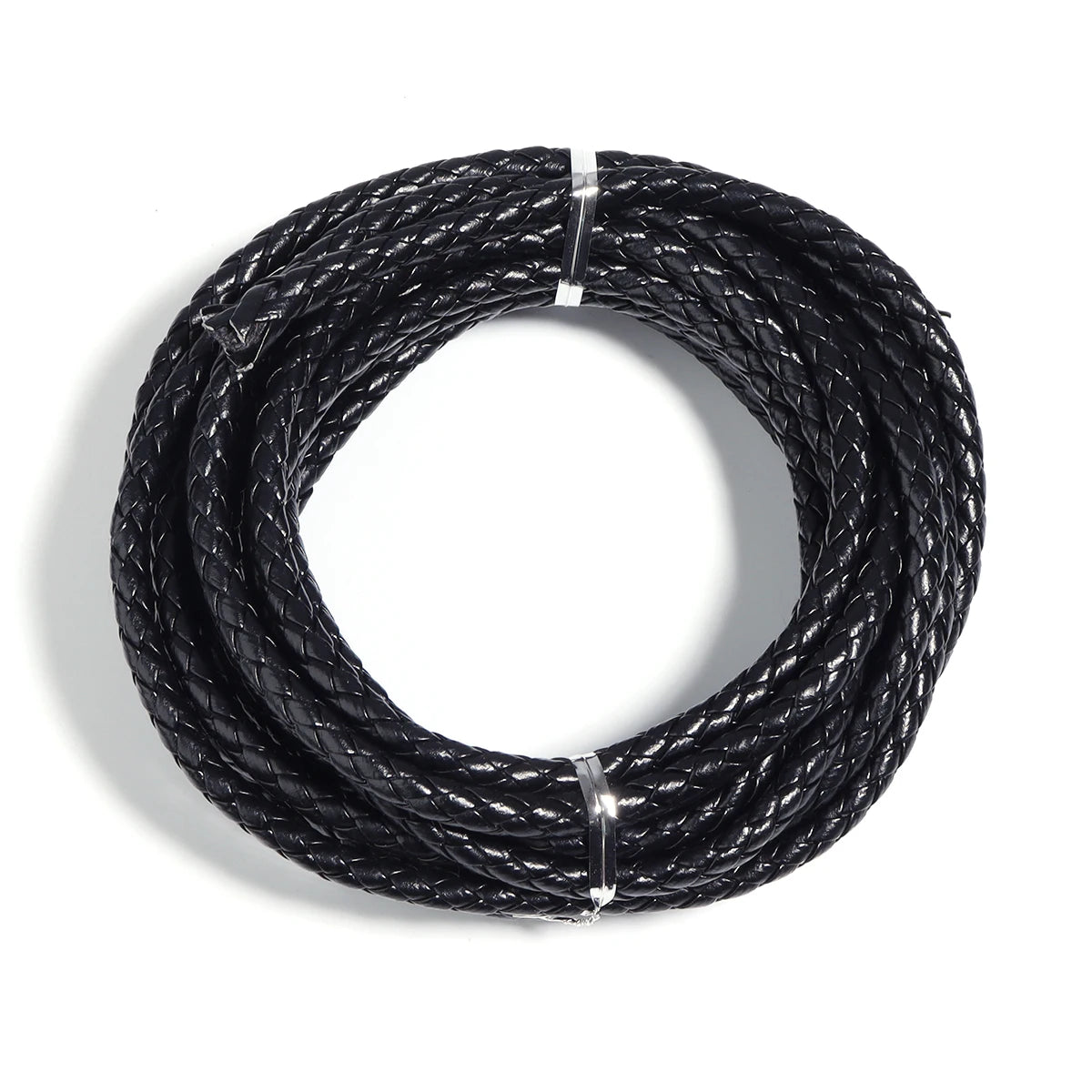 A coil of black round braided leather cord used for jewelry making and DIY crafts.