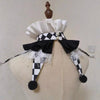 A handmade clown ruff collar featuring black and white checkered fabric, white ruffles, and black pom-poms.