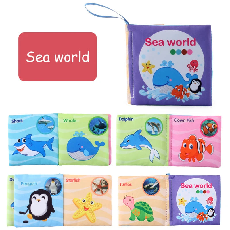 A set of soft cloth books featuring various sea animals like sharks, whales, dolphins, clownfish, penguins, and turtles.