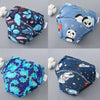 A set of four reusable cotton potty training pants for toddlers featuring various cute animal and space patterns.