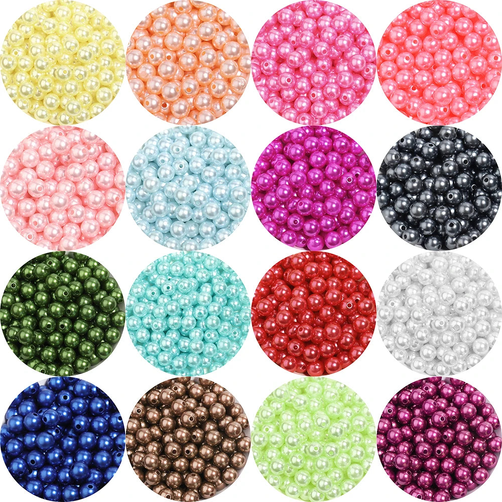 A collection of colorful imitation pearl beads in various shades including yellow, orange, pink, blue, purple, and green.