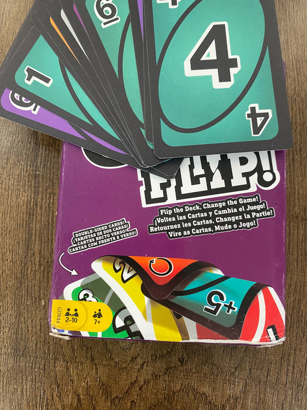 A box of the FLIP! card game showing several cards and a deck box with instructions.