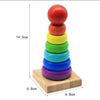 A stack of six colorful wooden rings in rainbow order, used as a Montessori shape and color sorter puzzle for toddlers.