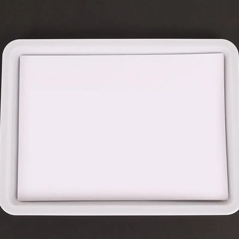 A white rectangular paint tray with a clear plastic insert for water marbling art.