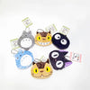 A collection of various plush toys featuring animals like a gray hippo, a yellow cat, and a dark blue animal.