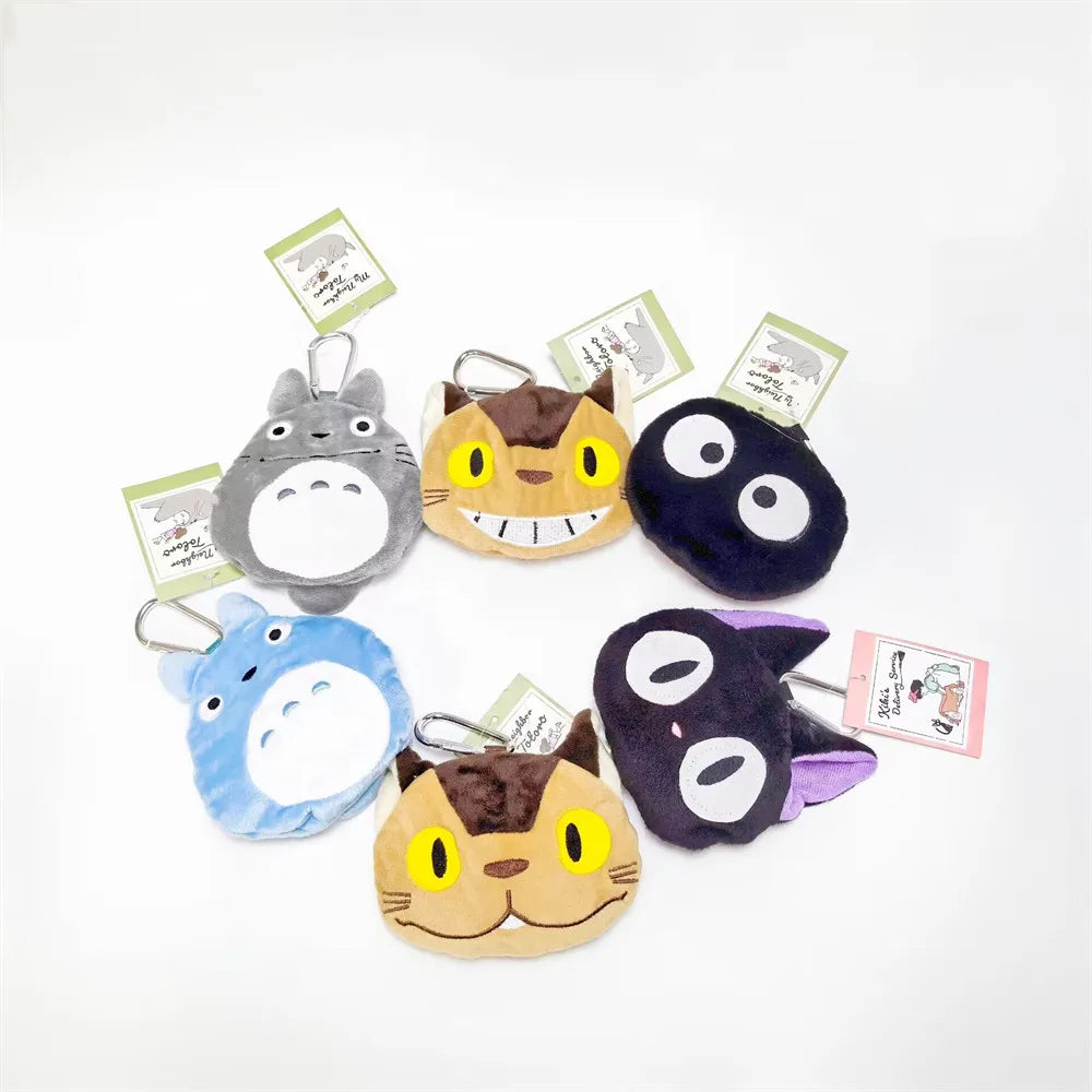 A collection of various plush toys featuring animals like a gray hippo, a yellow cat, and a dark blue animal.