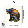 A wooden jigsaw puzzle depicting a bear in a mountainous forest landscape.