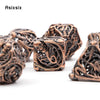 A set of coppery skull metal dice featuring intricate carvings, used for tabletop role-playing games.