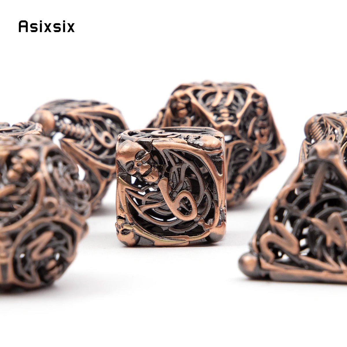 A set of coppery skull metal dice featuring intricate carvings, used for tabletop role-playing games.