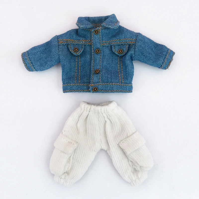 A denim jacket for a 1/12 scale doll, shown next to matching white knit pants.