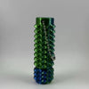 A green 3D printed spike roller fidget toy with a silver keychain, shown vertically.