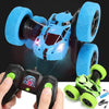 A blue RC car with large tires and LED lights is shown alongside its remote control transmitter.