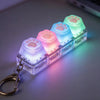 A clear plastic keychain fidget toy shaped like a paw print with glowing LED lights in pastel colors.