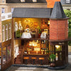A detailed wooden dollhouse kit of a pink princess villa with interior lighting and features.