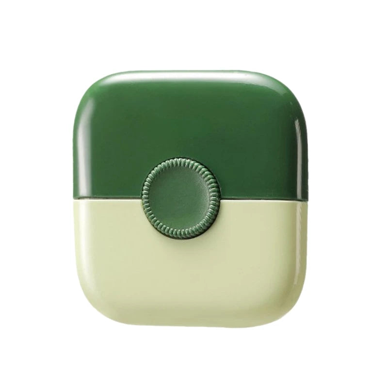 A green and cream dual-edge baby hair cutting comb with a round opening.