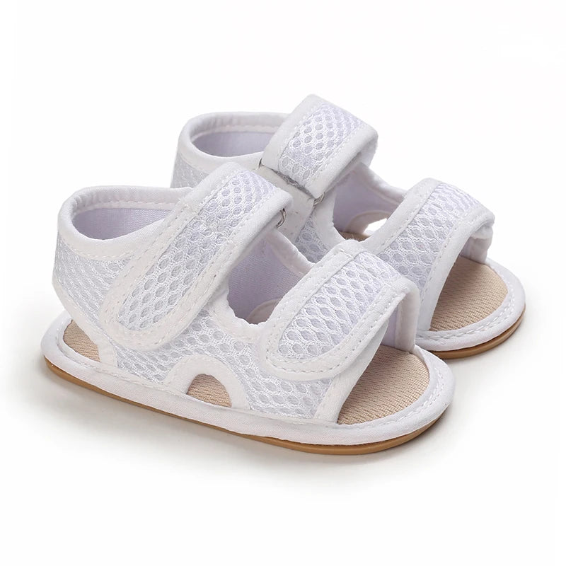 Pair of white breathable baby first walker sandals with soft anti-slip soles