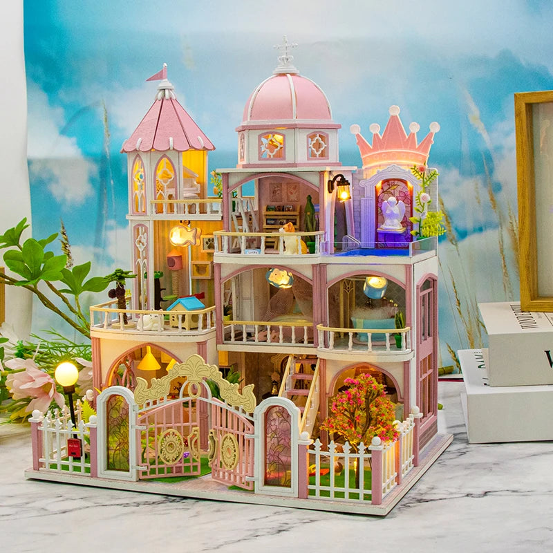 A detailed wooden dollhouse kit of a Windsor castle featuring pink and purple structures with LED lighting and furniture.
