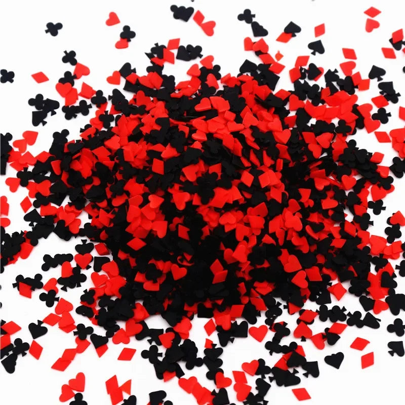 A pile of red and black polymer clay flower charms for DIY crafts and decoration.