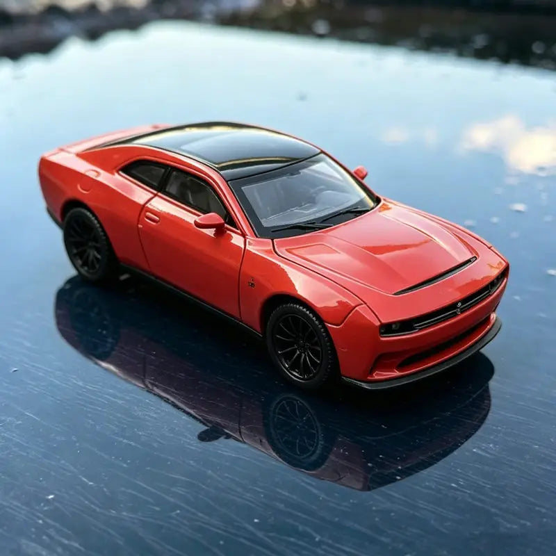 A bright orange Dodge Challenger SRT Hellcat diecast model car is reflected on a dark, wet surface.