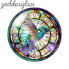 A round glass dome featuring a vibrant green bird in flight surrounded by colorful stained glass patterns.