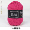 A skein of bright pink milk cotton yarn labeled with Chinese characters and a thread count of 74