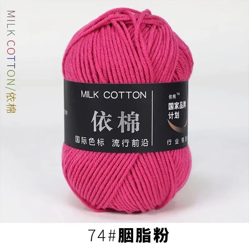 A skein of bright pink milk cotton yarn labeled with Chinese characters and a thread count of 74