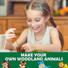 A young girl is sewing a woodland animal using a felt kit, smiling while working on her project.
