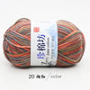 A skein of multi-colored yarn labeled as Zm Jane cotton yarn for knitting and crochet, showing various shades of orange, red,