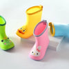A collection of bright yellow, pink, and blue rain boots for children displayed on a white surface.