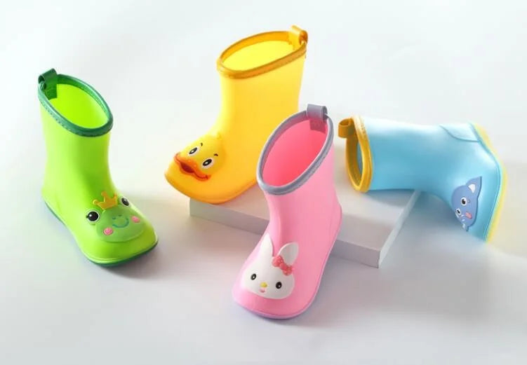A collection of bright yellow, pink, and blue rain boots for children displayed on a white surface.