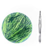 A circular silicone fidget picking pad with green lines and a metal tweezer tool.