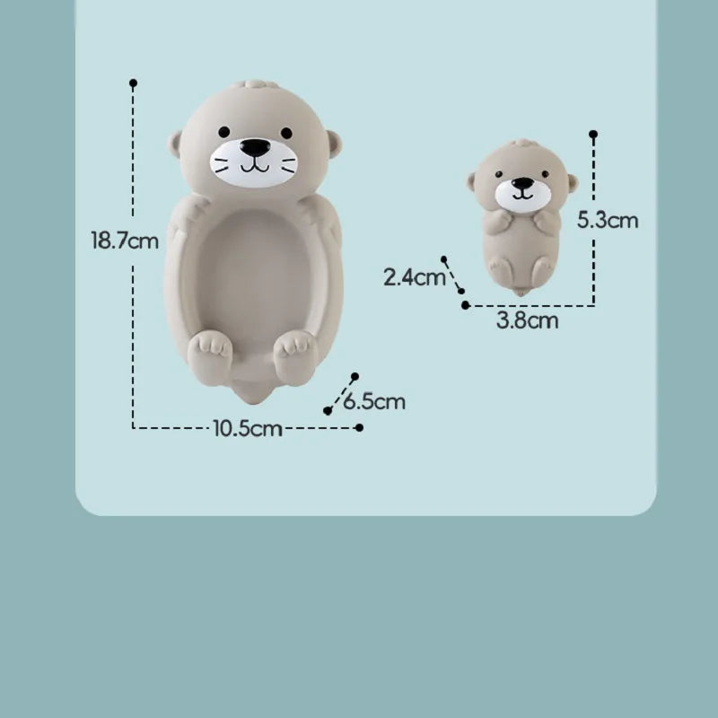 A light beige, glow-in-the-dark animal washing water toy shaped like a sleeping bear.
