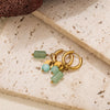 Gold hoop earrings featuring light green and blue-green gemstone beads on a neutral background.
