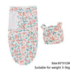 A white cotton newborn swaddle blanket and hat set with a floral print for a baby.