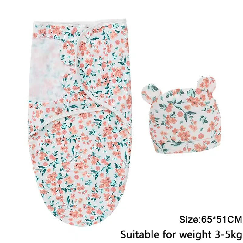 A white cotton newborn swaddle blanket and hat set with a floral print for a baby.