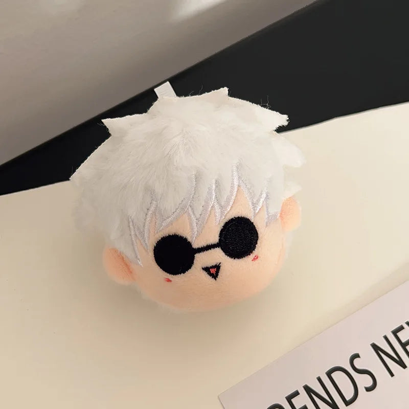 A white anime plush keychain pendant featuring spiky white hair and black sunglasses.