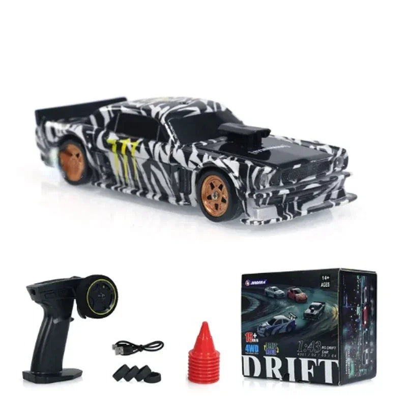 A black and white patterned mini RC drift car with wheels and a remote control box.