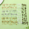A collection of vintage key charms in gold and silver tones arranged on a light green surface.