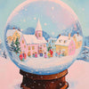 A diamond painting kit featuring a whimsical holiday scene of a village under a glowing glass sphere.