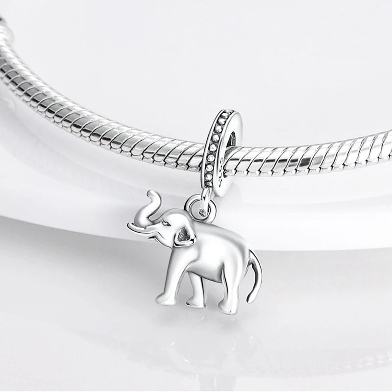 A sterling silver elephant charm bead attached to a silver chain, displayed on a white surface.