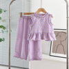 A purple and white checkered lace vest and wide-leg pants set displayed on a hanger.