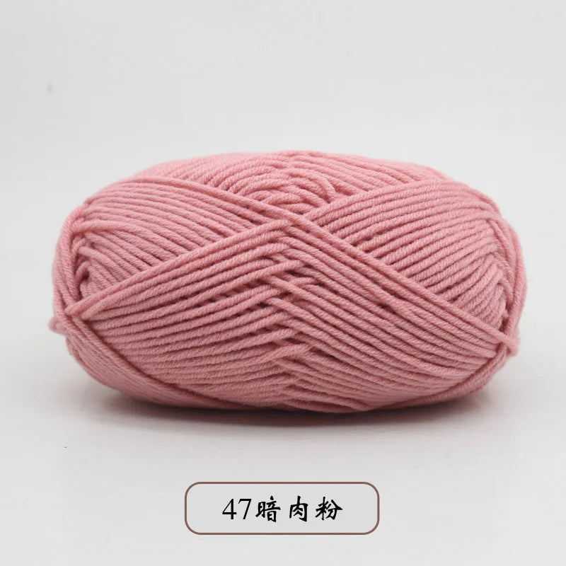 A ball of pink pre-dyed milk cotton yarn used for knitting and crochet.