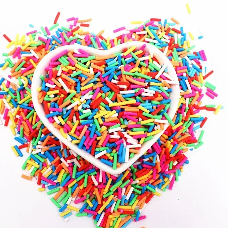 A heart-shaped bowl filled with colorful polymer clay sprinkles for slime and craft decor