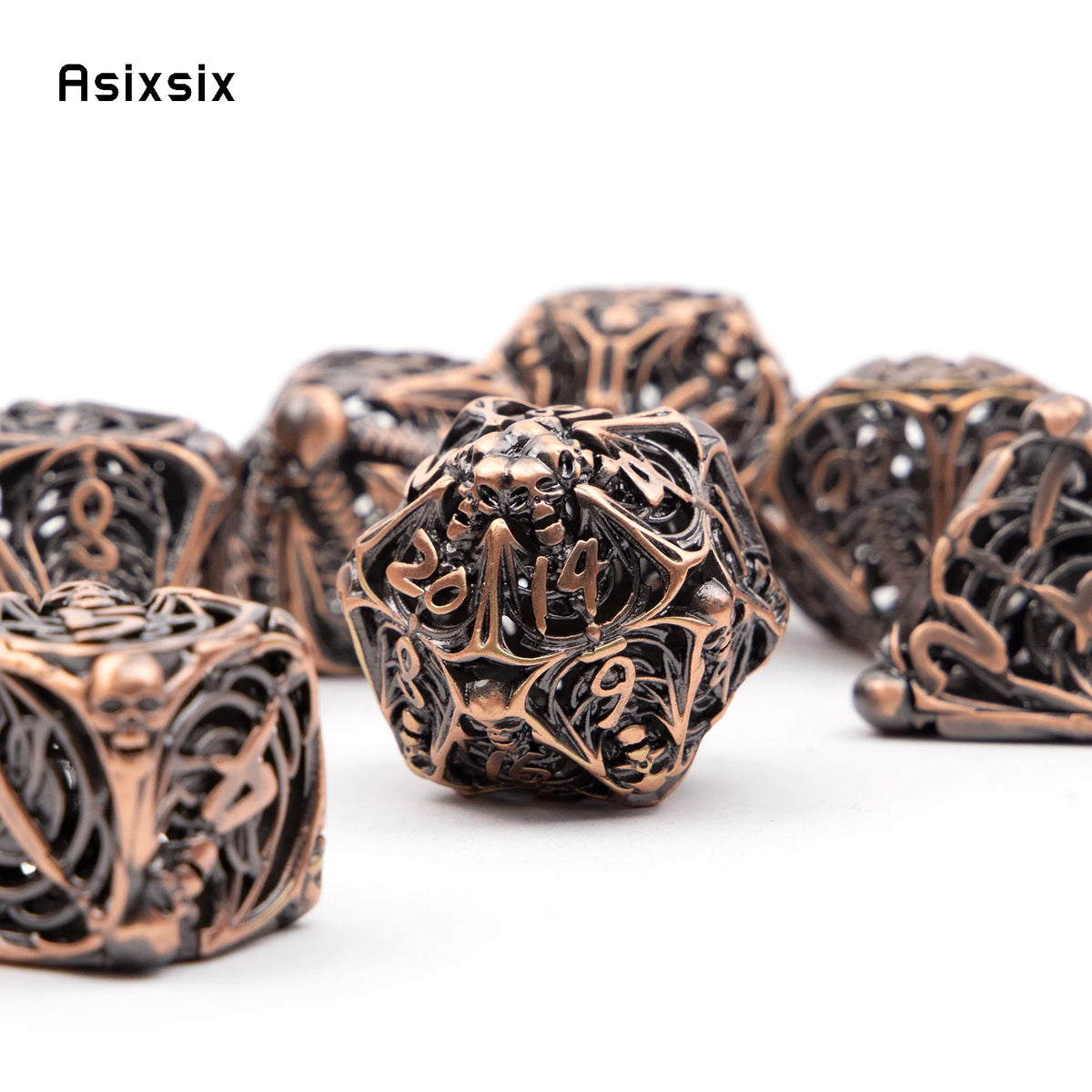 A set of coppery skull metal polyhedral dice for tabletop games, displayed on a white background.