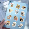 A collection of 200 cute animal stickers featuring dogs and puppies on a blue laptop surface.