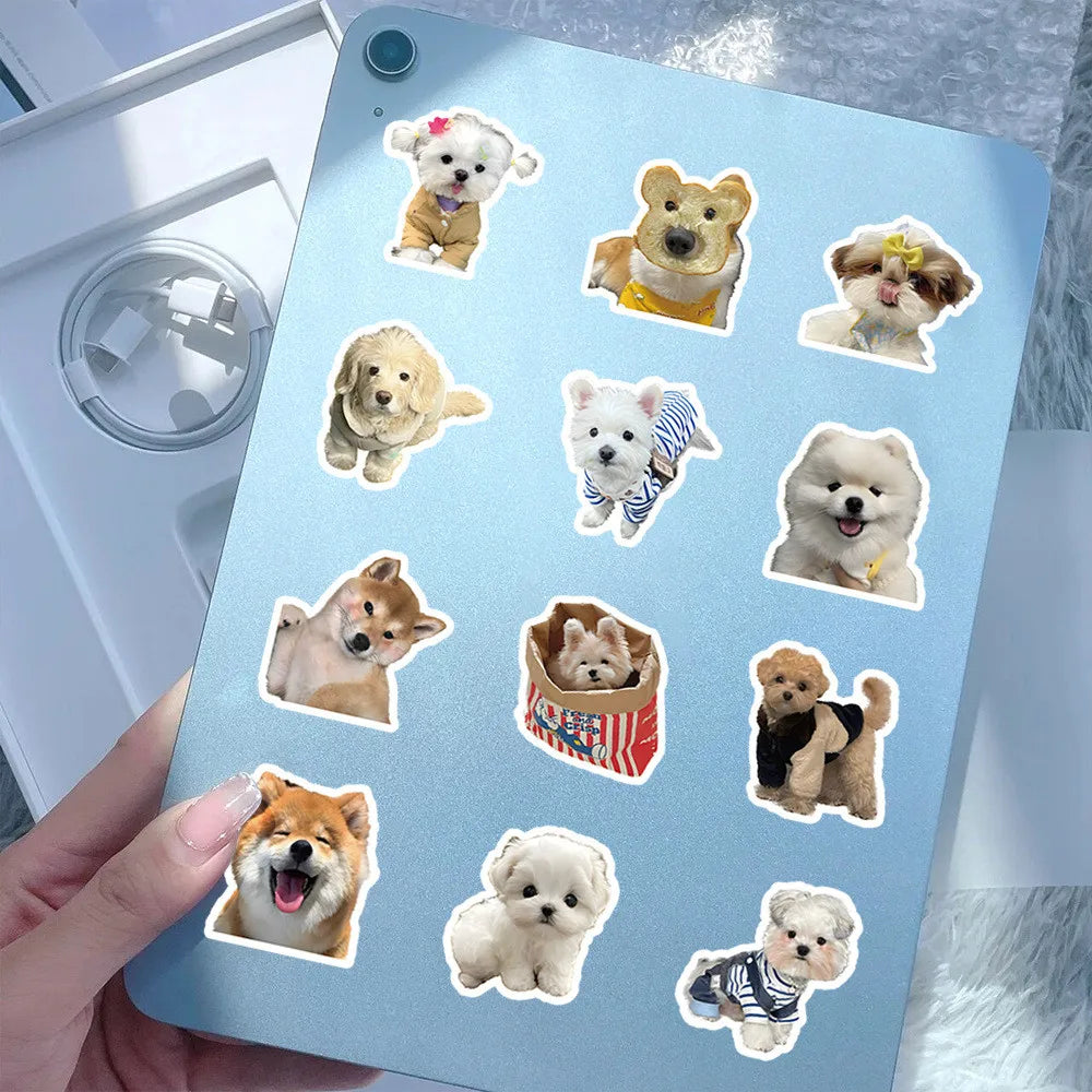 A collection of 200 cute animal stickers featuring dogs and puppies on a blue laptop surface.